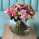 Assorted flowers in a large bowl vase - hydrangea and roses