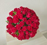 100 Red roses in a fish bowl vase - Dome shape