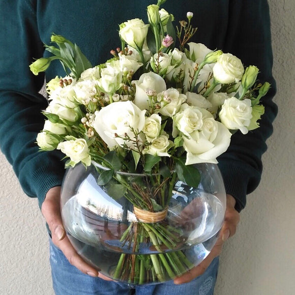 White flowers in a fish bowl vase