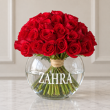 Red roses in a fish bowl vase
