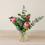 Proteas and eucalyptus in a vase