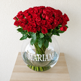 100 red roses in a fish bowl vase