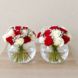 red and white roses in 2 fish bowl vases