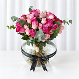 Assorted flowers in a fish bowl vase -purple