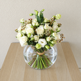 White flowers in a fish bowl vase