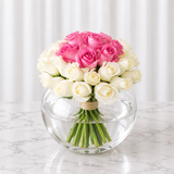 White and pink roses in a fish bowl vase