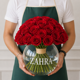 Red roses in a fish bowl vase