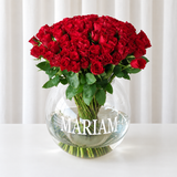 100 red roses in a fish bowl vase