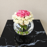 White and pink roses in a fish bowl vase