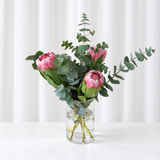Proteas and eucalyptus in a vase