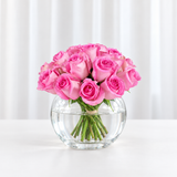 Pink roses in a fish bowl vase