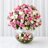 Assorted flowers in a large bowl vase