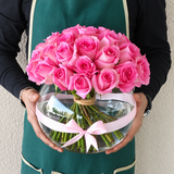 Pink roses in a fish bowl vase
