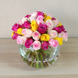 Assorted flowers in a fish bowl vase -