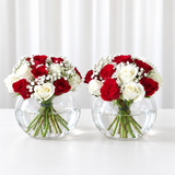 red and white roses in 2 fish bowl vases