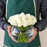 White roses in a fish bowl vase