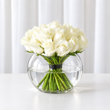 White roses in a fish bowl vase