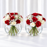 Red and white roses in a fish bowl vase