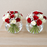 Red and white roses in a fish bowl vase