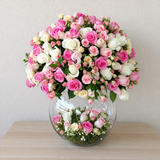 Assorted flowers in a large bowl vase