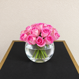 Pink roses in a fish bowl vase