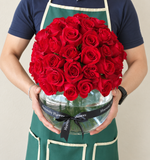 Red roses in a fish bowl vase - Dome shape