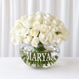White roses in a fish bowl vase