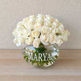 White roses in a fish bowl vase
