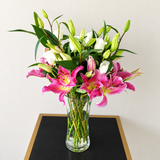 Pink lilies and white roses in a vase