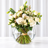 White flowers in a fish bowl vase