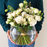White flowers in a fish bowl vase