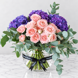 purple hydrangea and pink flowers in a fishbowl