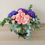 purple hydrangea and pink flowers in a fishbowl