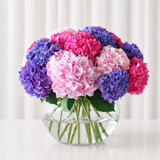 Hydrangea flowers in a large fish bowl vase