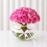 Pink roses in a fish bowl vase