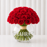 Red roses in a fish bowl vase