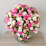 Assorted flowers in a large bowl vase