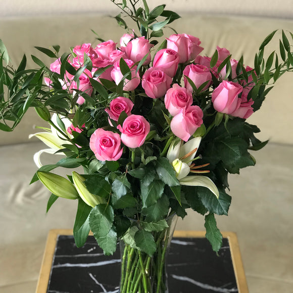 Pink roses and lilies in a vase