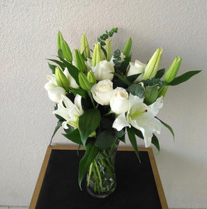 White lilies and white roses in a vase