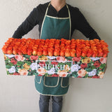 100 orange Roses in A long Colorful box