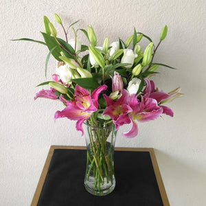 Pink lilies and white roses in a vase