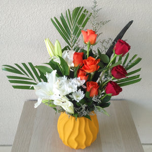 arrangement of red & orange roses in a vase