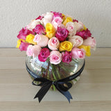 Assorted flowers in a fish bowl vase -