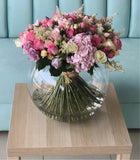 Assorted flowers in a large bowl vase - hydrangea and roses