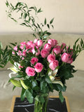 Pink roses and lilies in a vase
