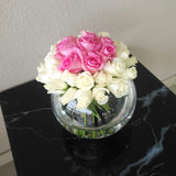 White and pink roses in a fish bowl vase
